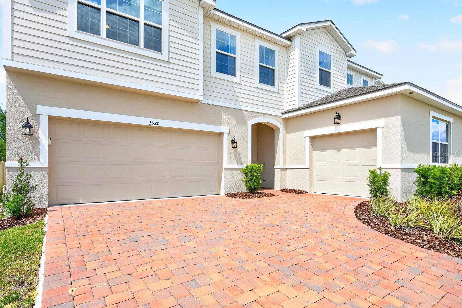 3520 BANANA SHRUB BOULEVARD, Clermont, FL 34711 From the moment you arrive, the home impresses with its paver driveway, COURTYARD-STYLE 3-CAR GARAGE, and attractive curb appeal.