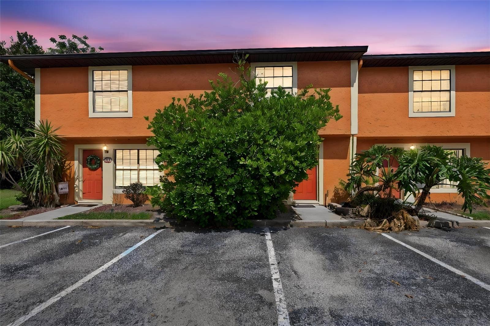 3371 RIVER VIEW WAY, #46, Winter Park, FL 32792 Two-story townhome-style exterior with stucco finish, private entry, and assigned parking steps from the front door.