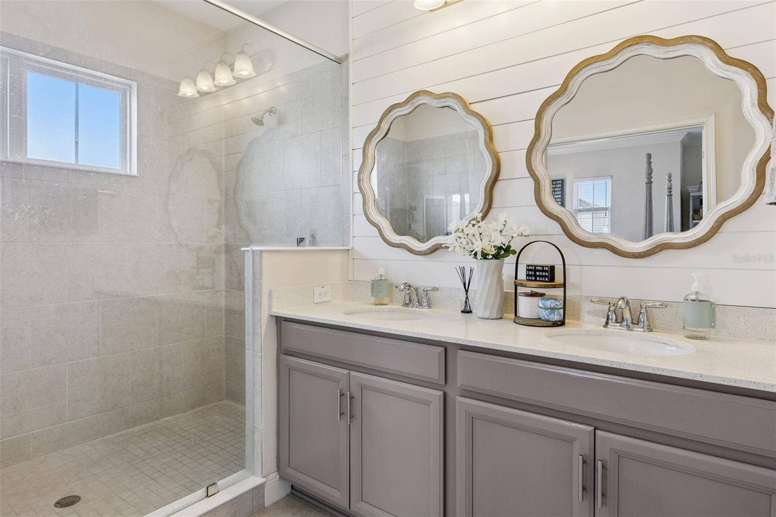 907 EASLEY AVENUE, Winter Garden, FL 34787 Primary bath features dual sinks, an oversized shower, linen closet, and private toilet.