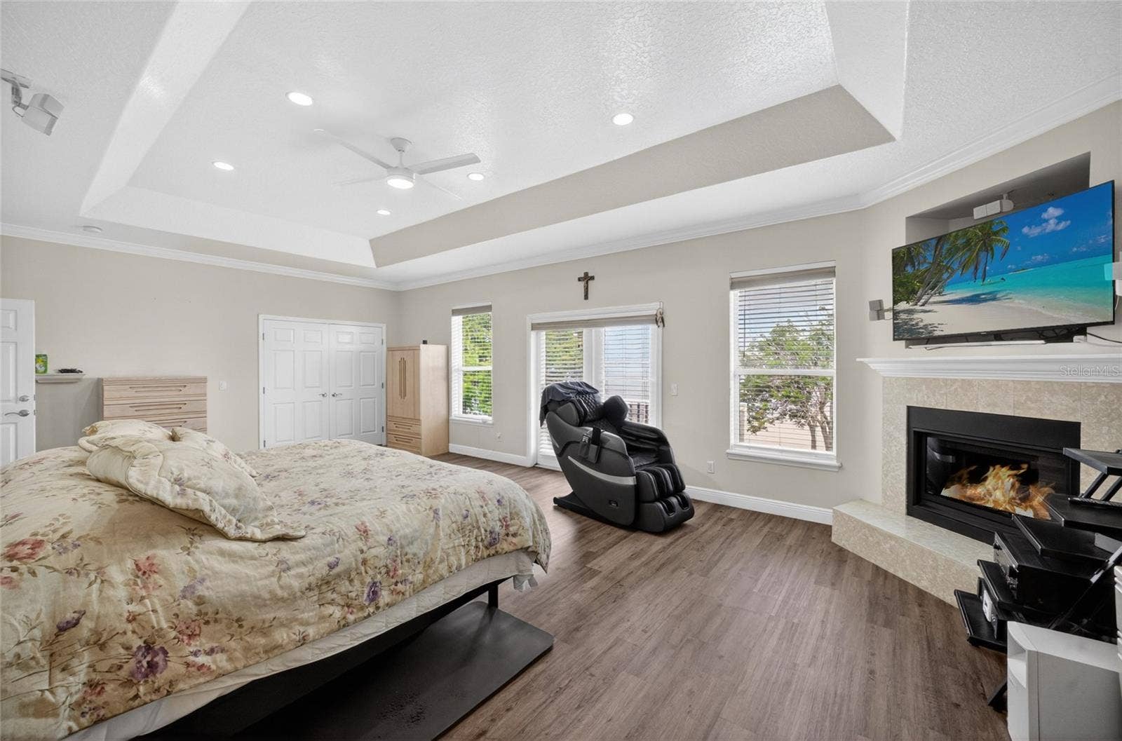 279 ZACHARY WADE STREET, Winter Garden, FL 34787 Primary bedroom with lovely corner fireplace and 2 closets. Plenty of lake views from the bedroom windows and from the balcony