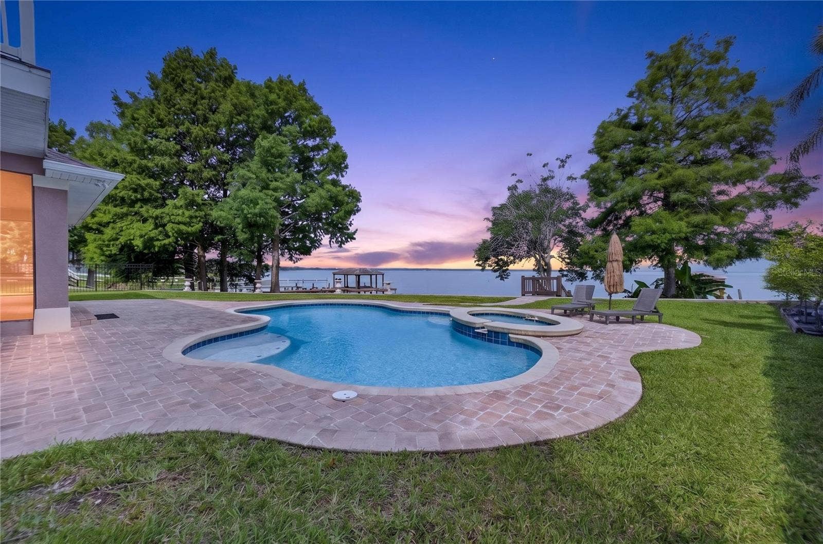 279 ZACHARY WADE STREET, Winter Garden, FL 34787 Amazing sunsets from the incredible outdoor living space with well designed heated pool and raised spa, lounging area and dock
