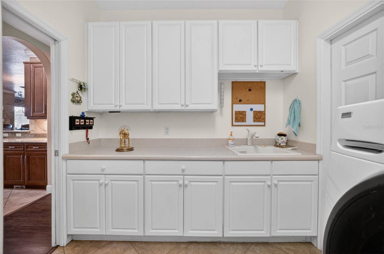 279 ZACHARY WADE STREET, Winter Garden, FL 34787 White cabinets in the laundry room