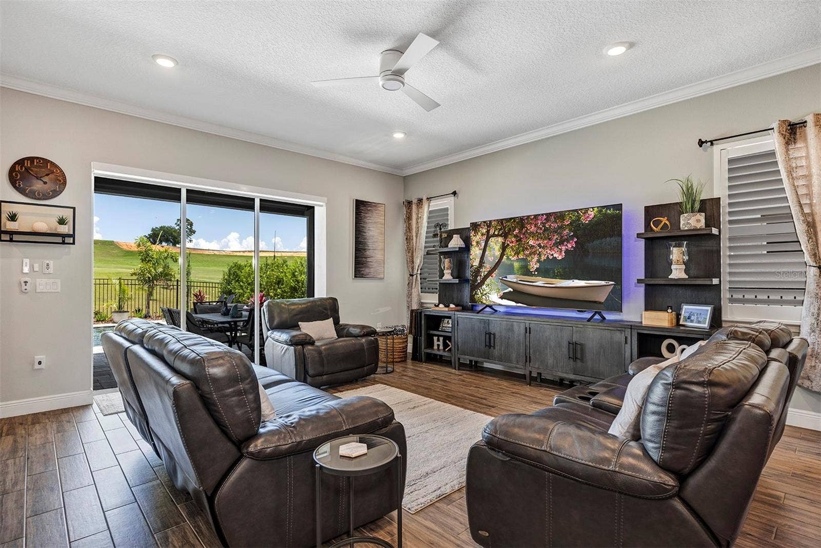 16136 VOLTERRA POINT, Bella Collina, FL 34756 Family room with sliders to pool and golf course view