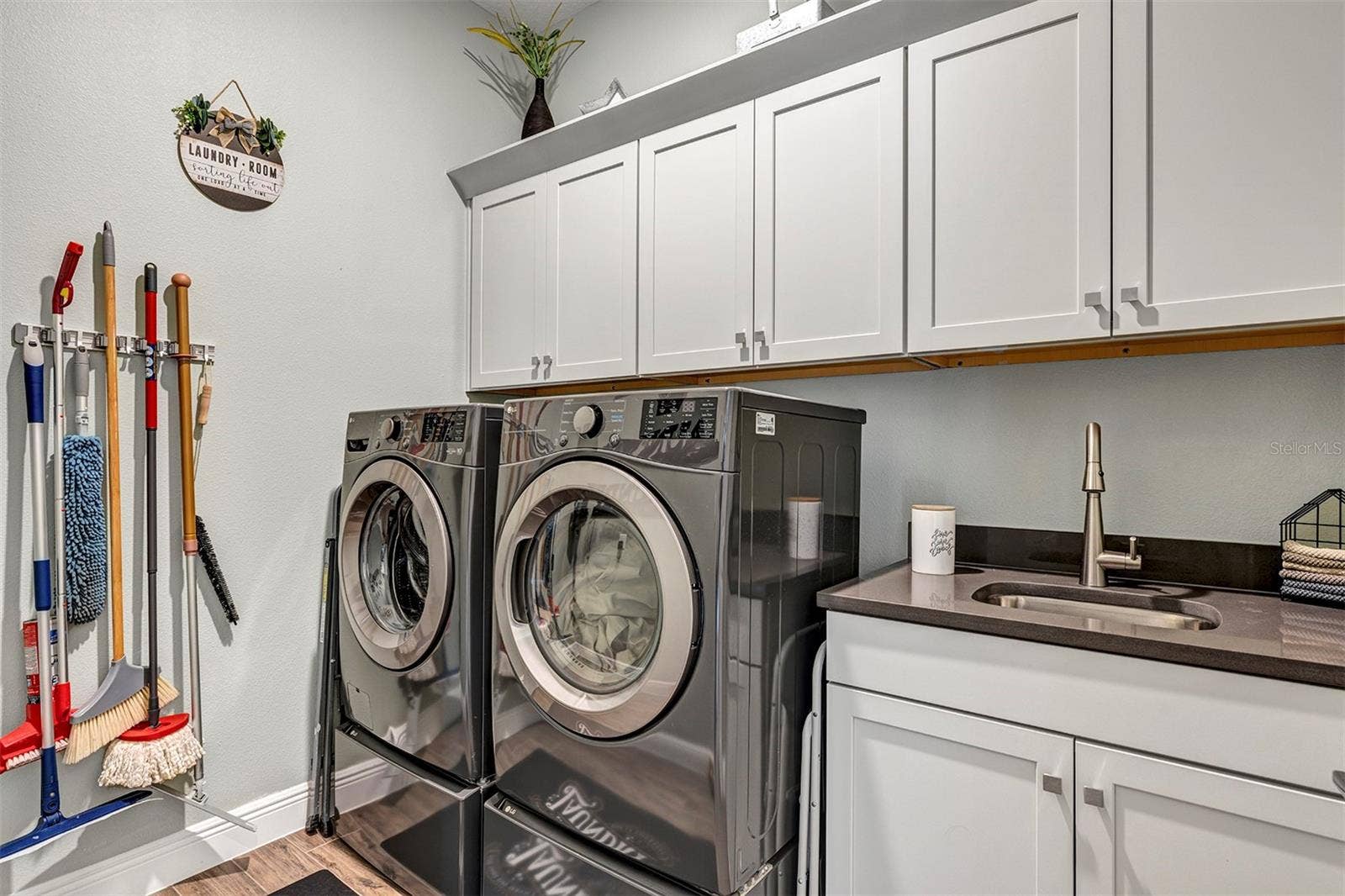 16136 VOLTERRA POINT, Bella Collina, FL 34756 Inside laundry room with built ins and utility sink