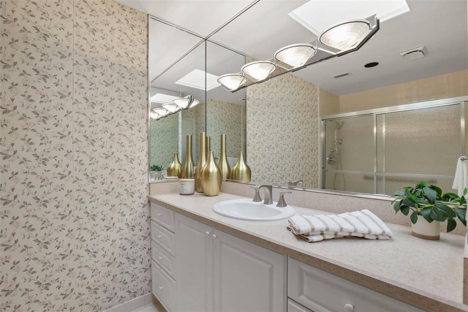 300 CAROLINA AVENUE, #402C, Winter Park, FL 32789 The primary bathroom offers abundant storage in a large vanity area and a full linen closet.