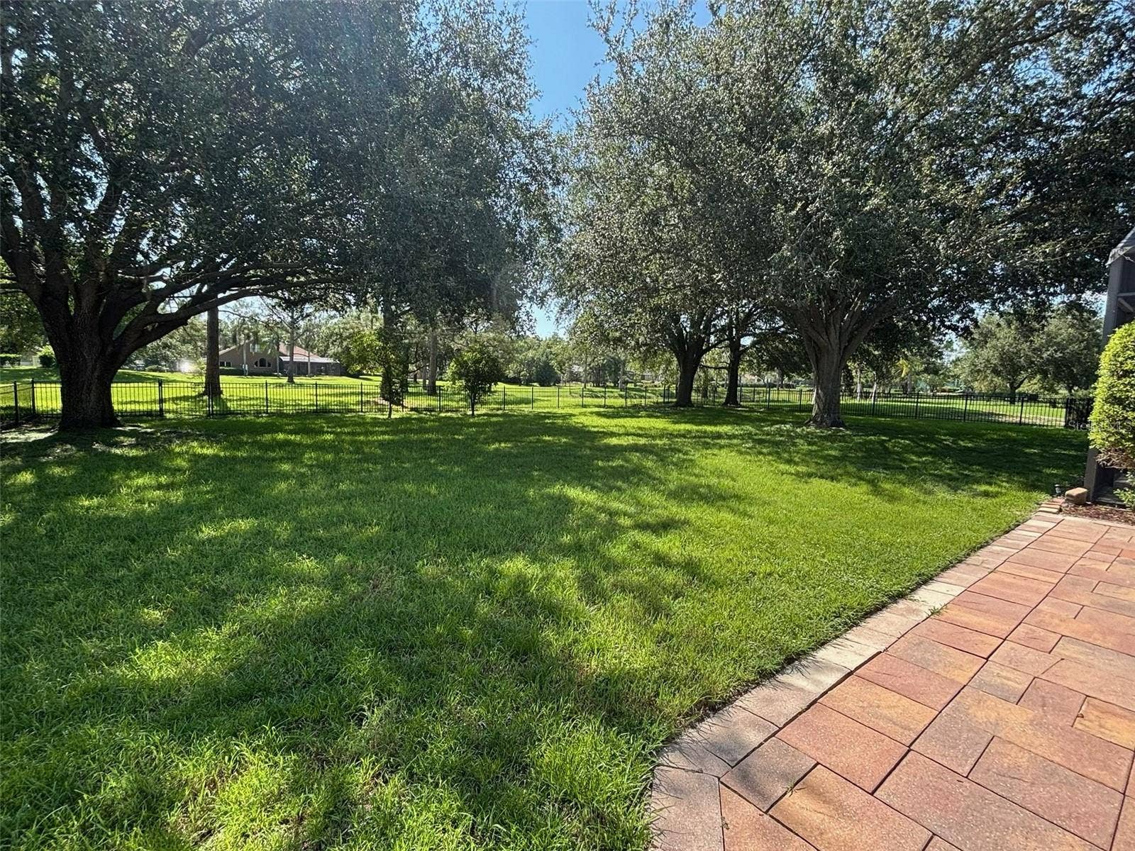 VIEW OF YARD LOOKING ACROSS TO THE HOA GREEN SPACE IN THE MIDDLE OF THE NEIGHBORHOOD