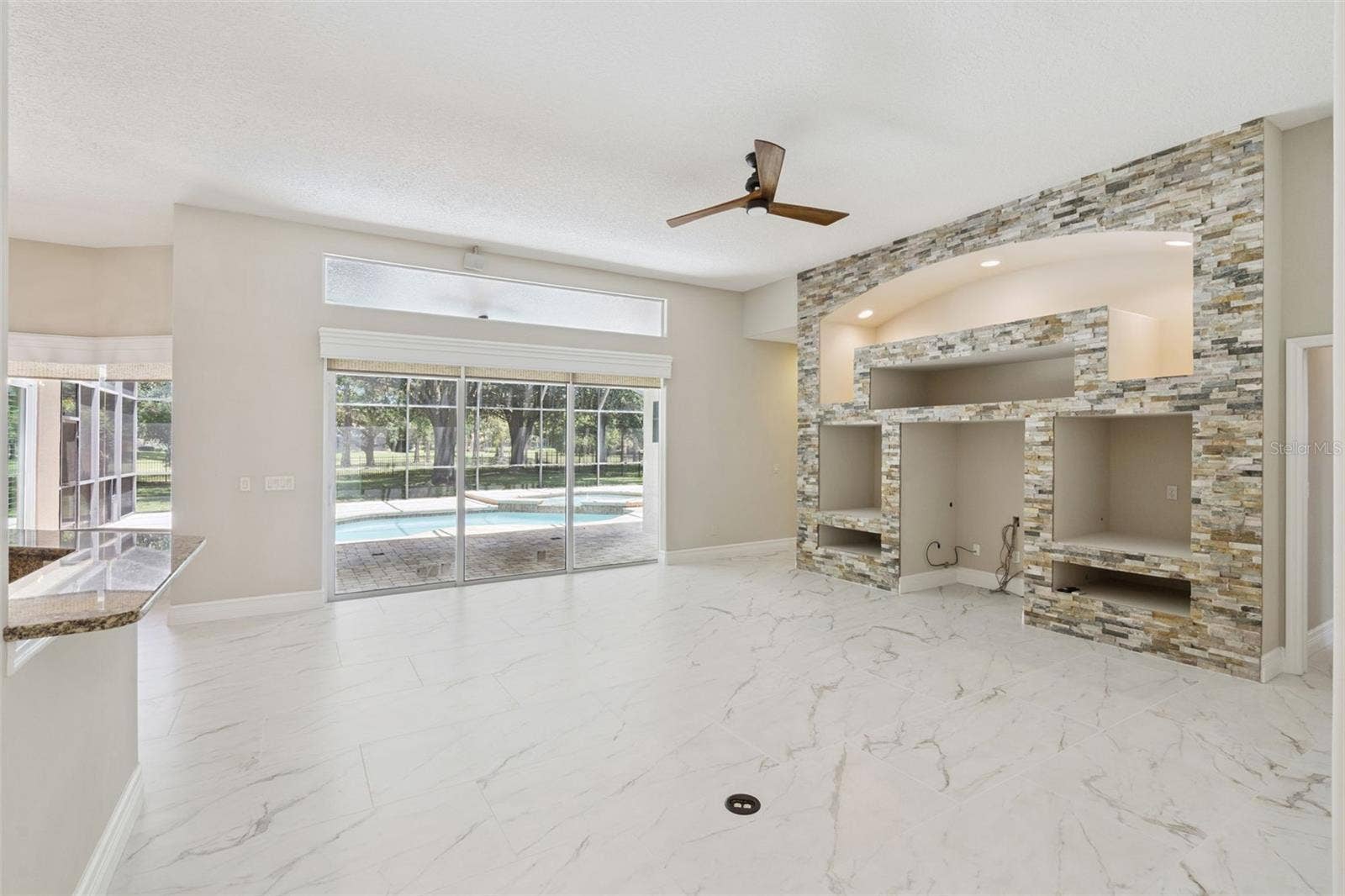 FAMILY ROOM WITH VIEW OUT TO POOL
