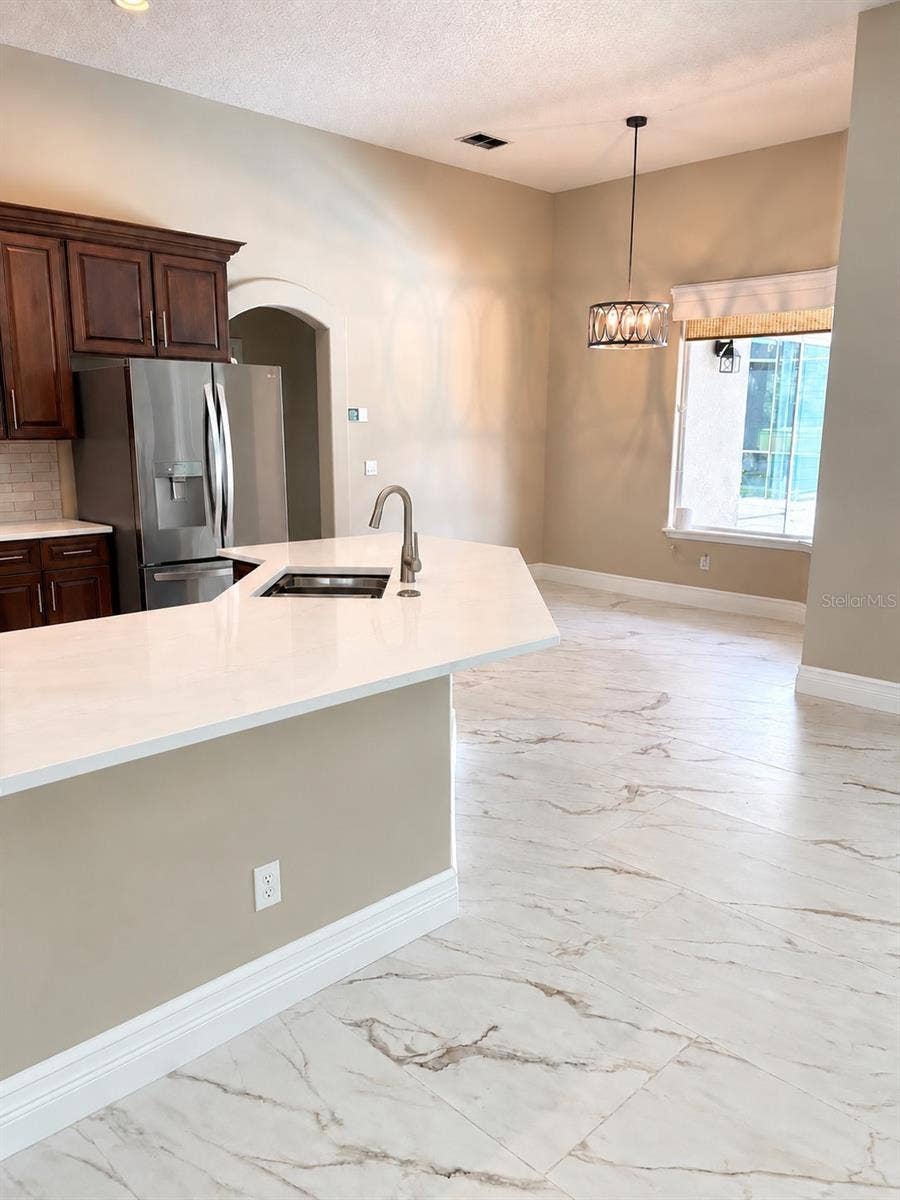 Roomy breakfast room overlooks the patio and pool