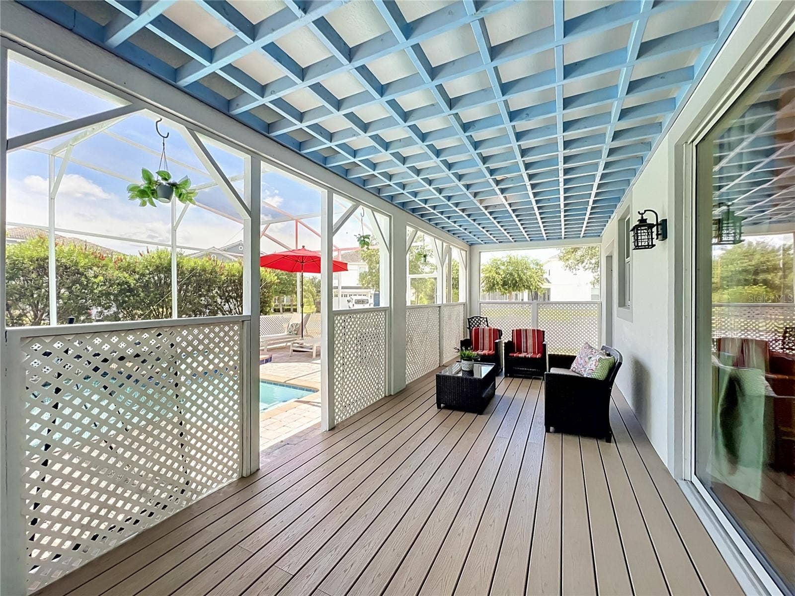 1573 MAIDSTONE COURT, Davenport, FL 33896 Covered lanai with upgraded wood flooring / wood ceiling accents.
