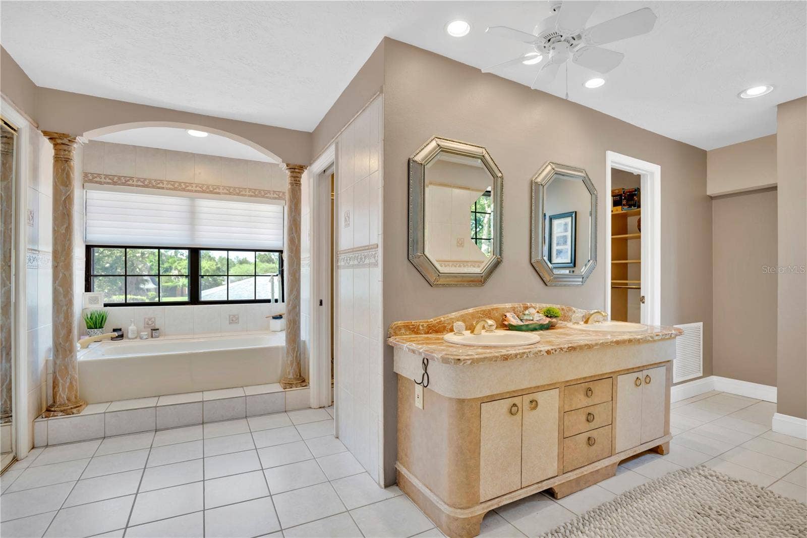1367 CAMPBELL STREET, Orlando, FL 32806 The primary bathroom offers dual walk-in closets, a soaking tub, and a separate shower.