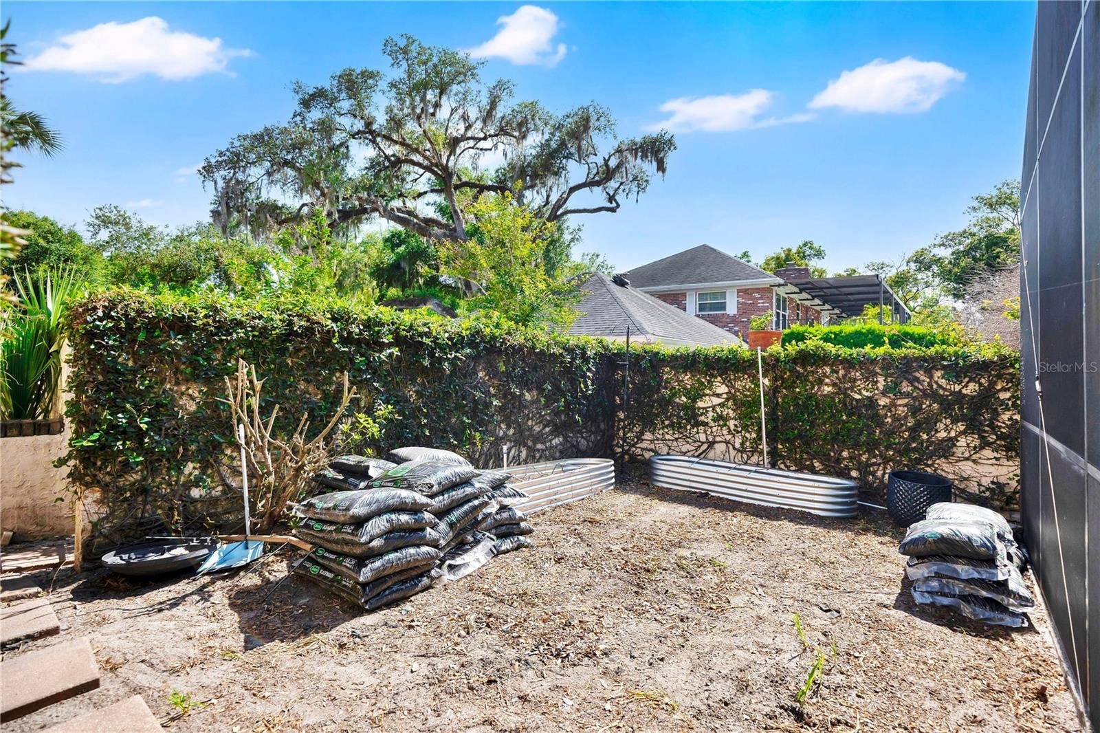 1367 CAMPBELL STREET, Orlando, FL 32806 In addition to a spacious backyard, there is also a private garden area off of the pool.