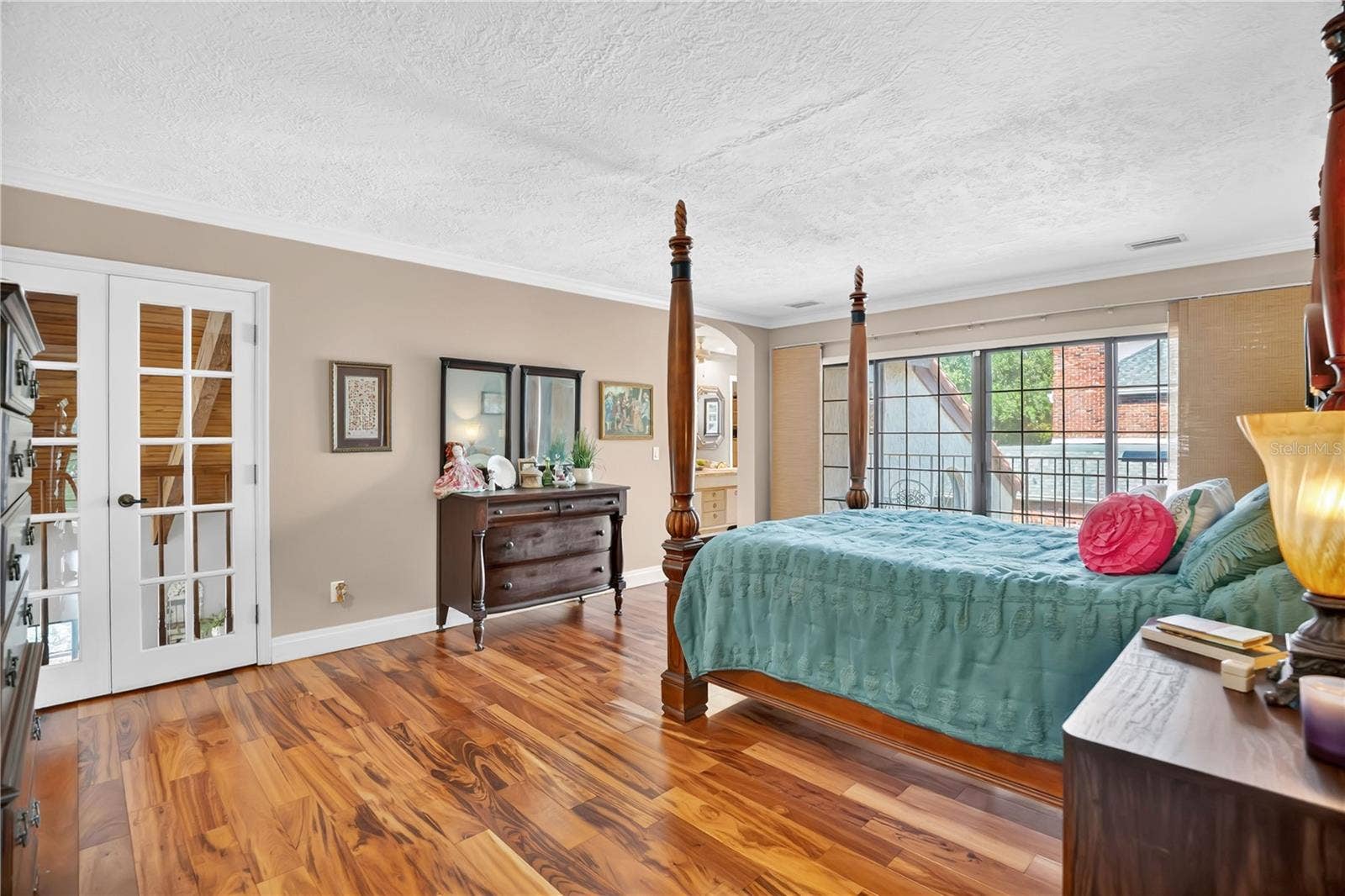 1367 CAMPBELL STREET, Orlando, FL 32806 The primary suite has a private balcony overlooking the main courtyard as well as a Juliet balcony looking into the great room.