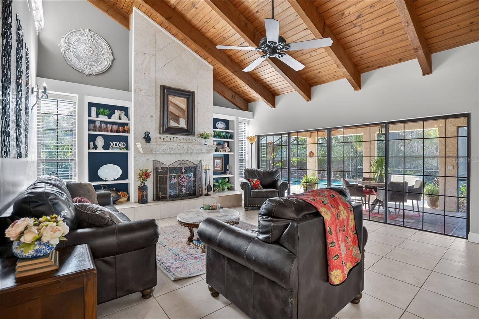 1367 CAMPBELL STREET, Orlando, FL 32806 The great room with exposed wood beams and wood-burning fireplace
