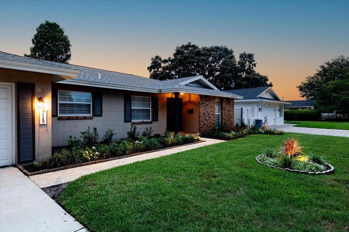 715 S RANGER BOULEVARD, Winter Park, FL 32792 Front of house at twilight.