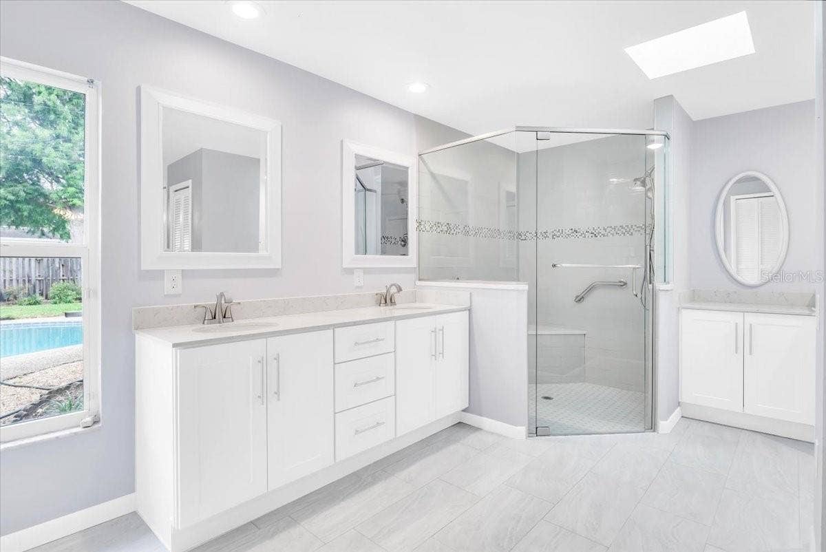 715 S RANGER BOULEVARD, Winter Park, FL 32792 Newly remodeled primary suite bathroom with modern tile, fixtures, and granite.