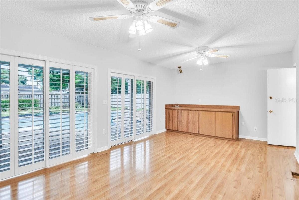 715 S RANGER BOULEVARD, Winter Park, FL 32792 Living area #3 with beautiful hardwood flooring and wet bar.