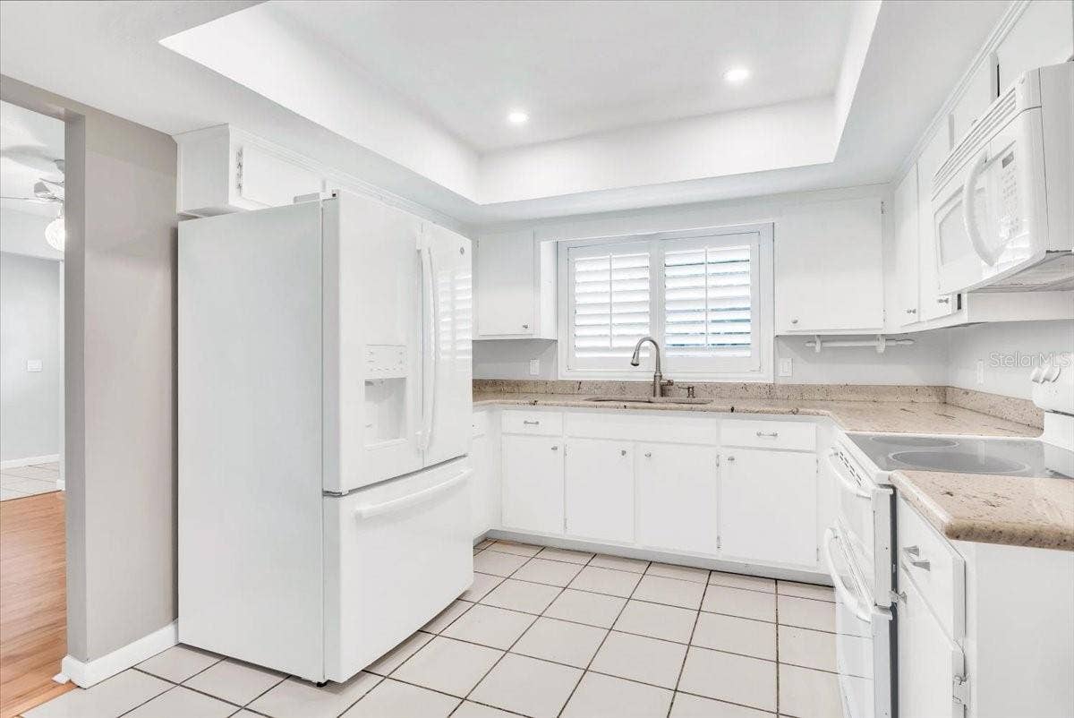 715 S RANGER BOULEVARD, Winter Park, FL 32792 Kitchen area with granite countertops and plantation style shutters.