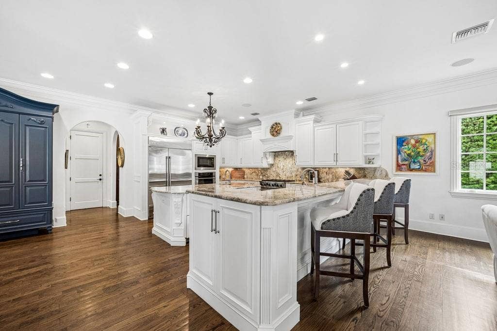 1571 WOODLAND AVENUE, Winter Park, FL 32789 Updated kitchen with ample storage and bar eating area.