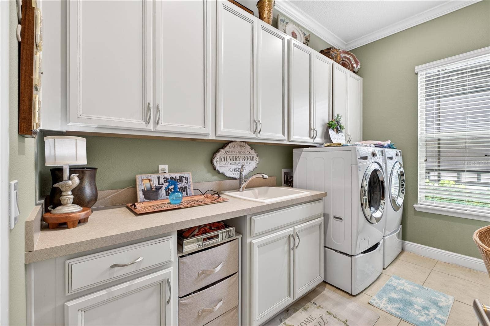 1651 AMSEL FALLS PARK TERRACE, Winter Garden, FL 34787 laundry room featuring washer and dryer, sink and cabinates.