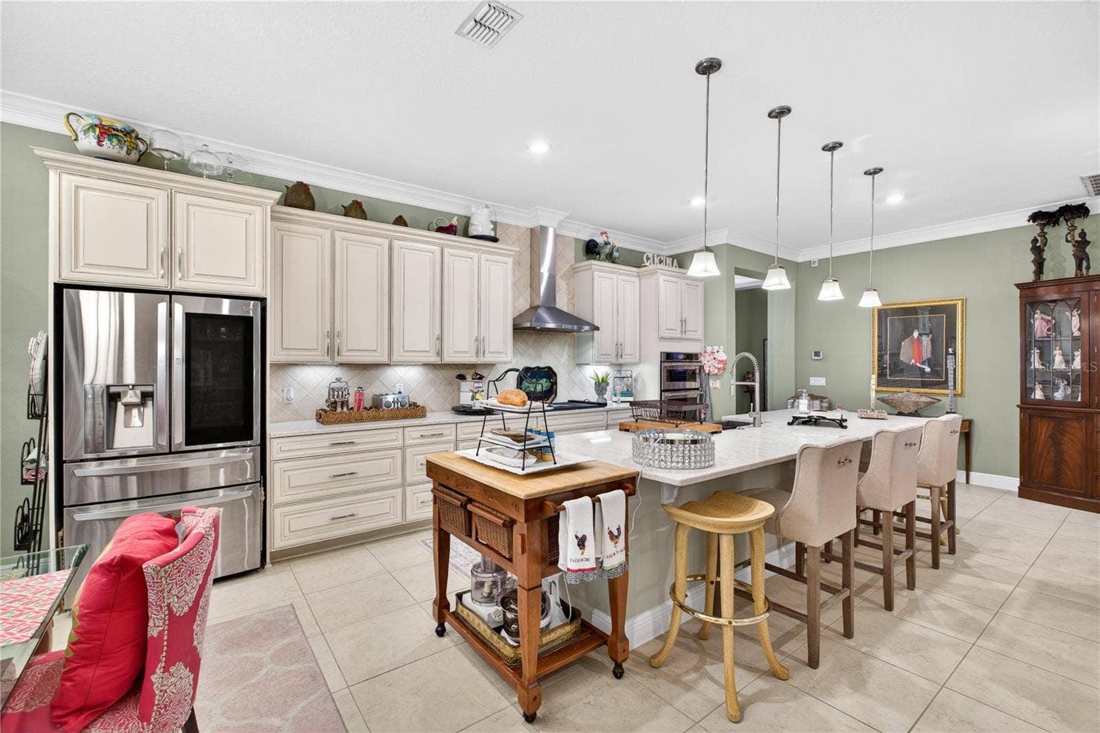1651 AMSEL FALLS PARK TERRACE, Winter Garden, FL 34787 Open-concept designer kitchen featuring stainless steel appliances and a center island.
