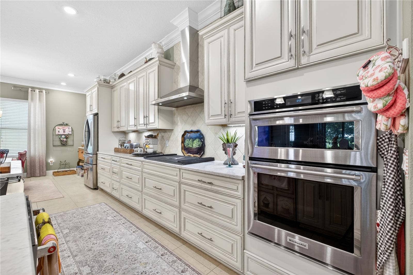 1651 AMSEL FALLS PARK TERRACE, Winter Garden, FL 34787 Open-concept designer kitchen featuring stainless steel appliances and a kitchen vent.