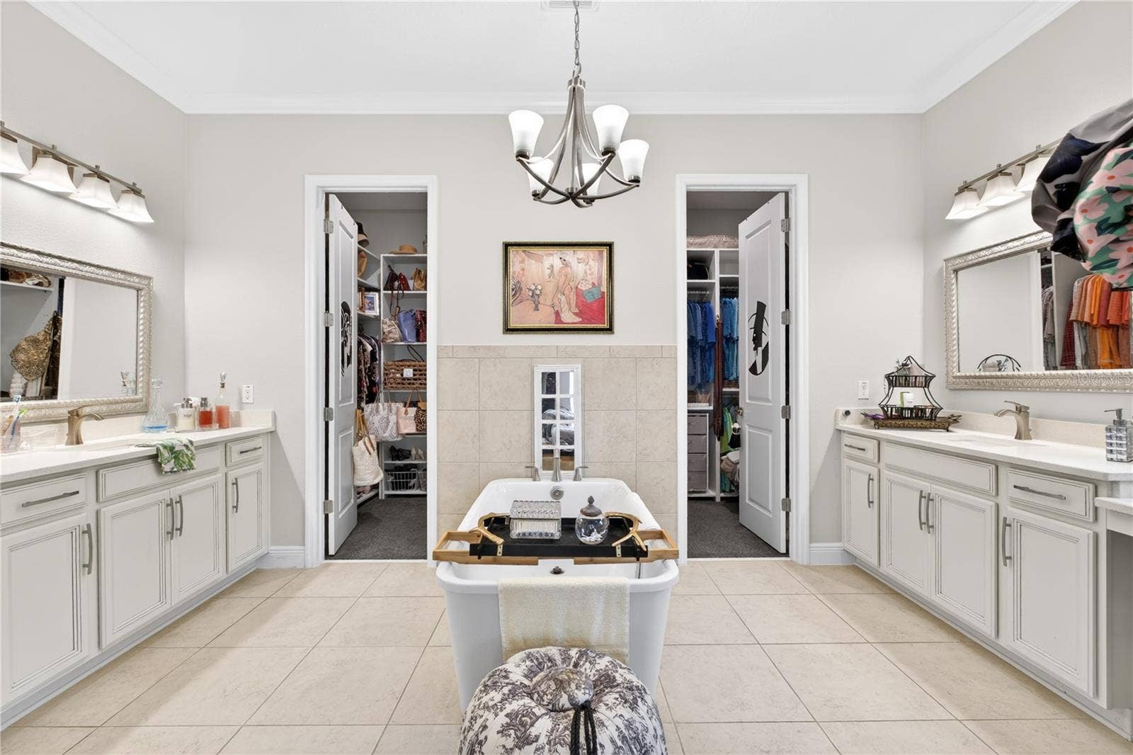 1651 AMSEL FALLS PARK TERRACE, Winter Garden, FL 34787 The owner's suite bathroom features a spacious walk-in closet, dual vanities situated on opposite sides, and a central bathtub.