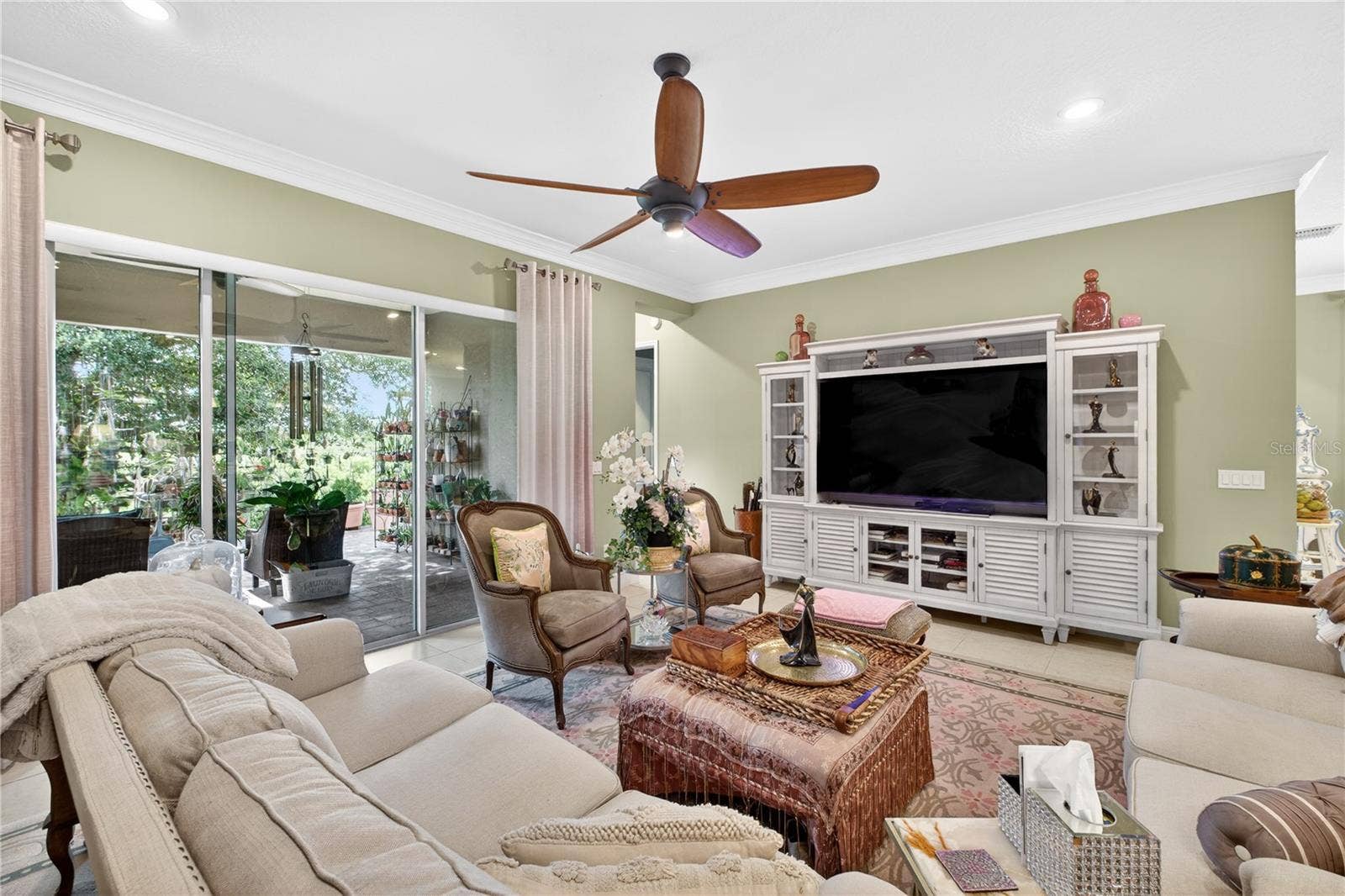 1651 AMSEL FALLS PARK TERRACE, Winter Garden, FL 34787 View of the backyard and porch from the family room through the sliding glass doors.