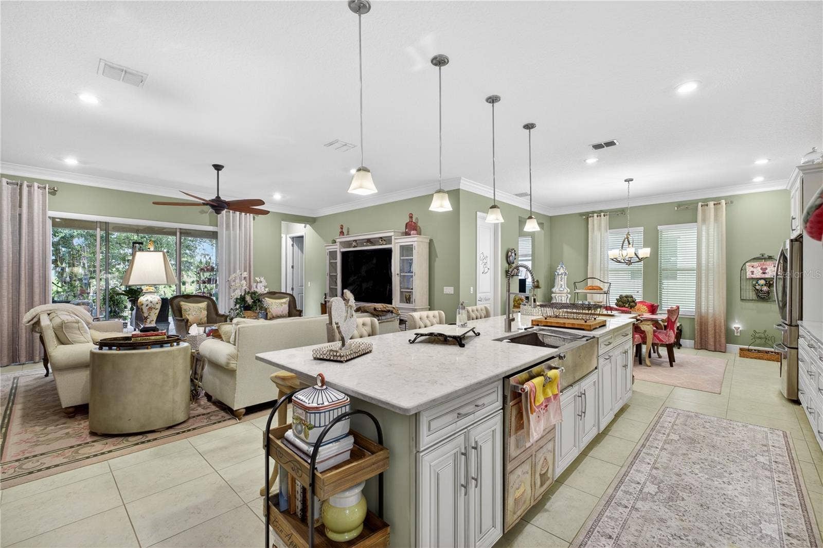 1651 AMSEL FALLS PARK TERRACE, Winter Garden, FL 34787 Open-concept living space featuring a family room with sliding glass door access.