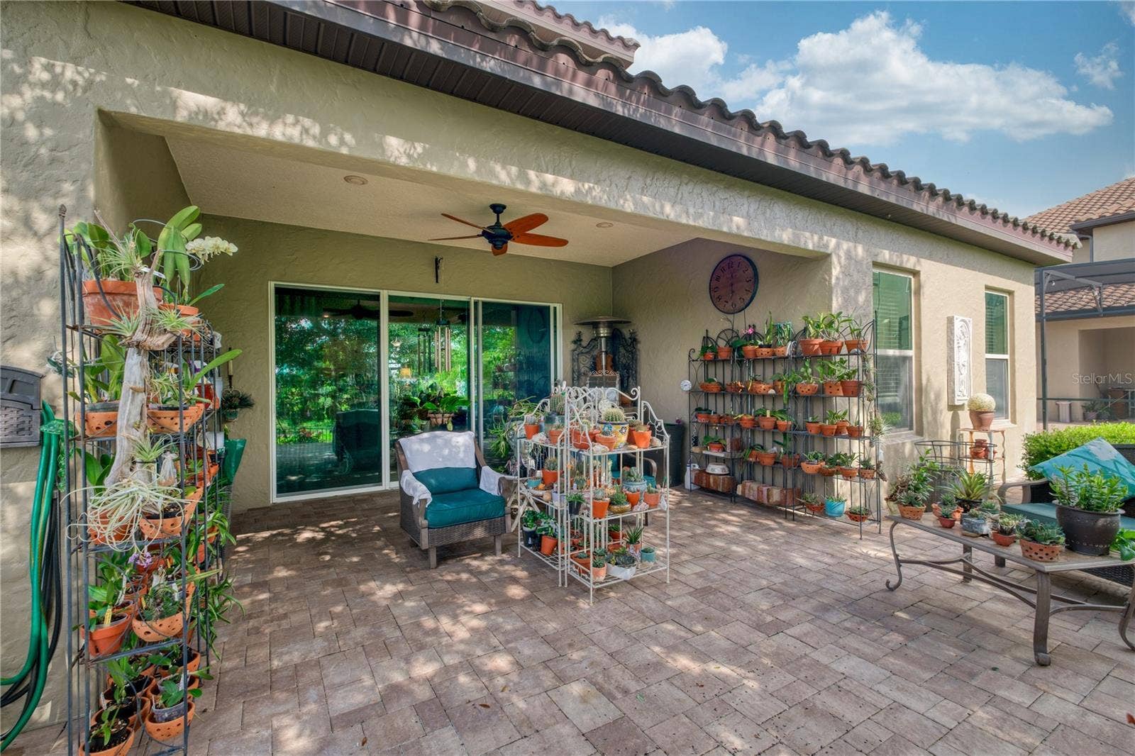 1651 AMSEL FALLS PARK TERRACE, Winter Garden, FL 34787 backyard porch featuring sliding doors from behind.