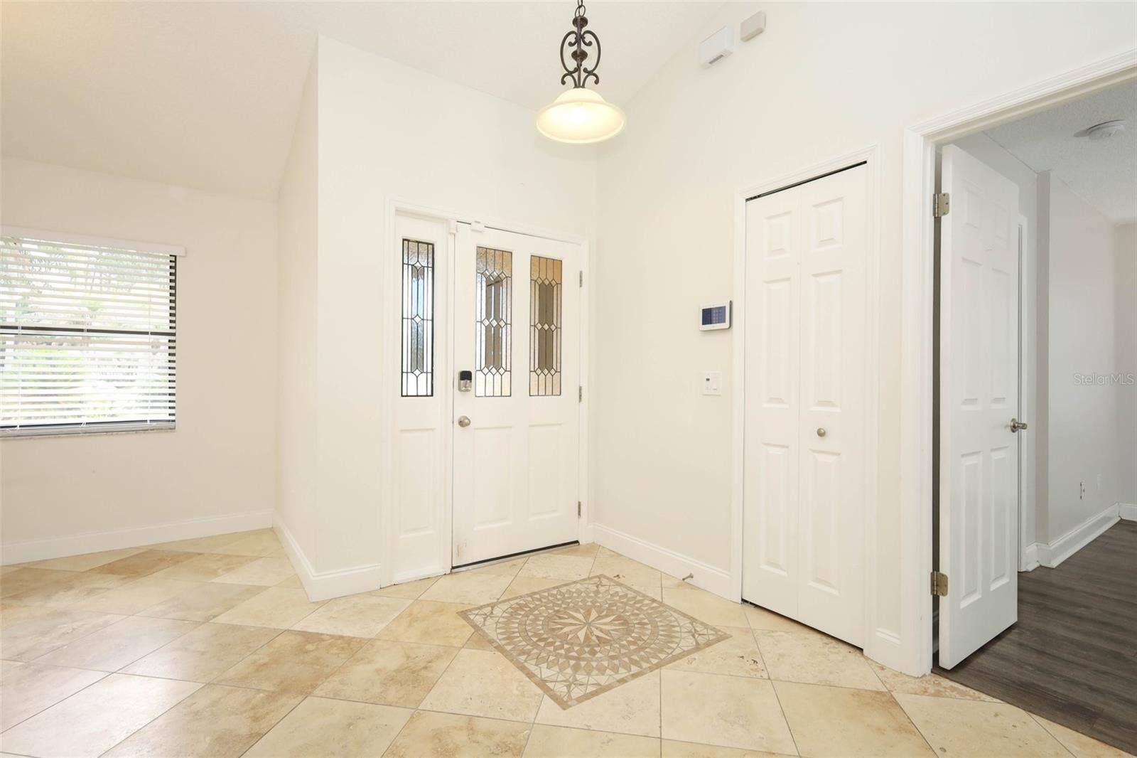 Foyer with Travertine tile flooring.