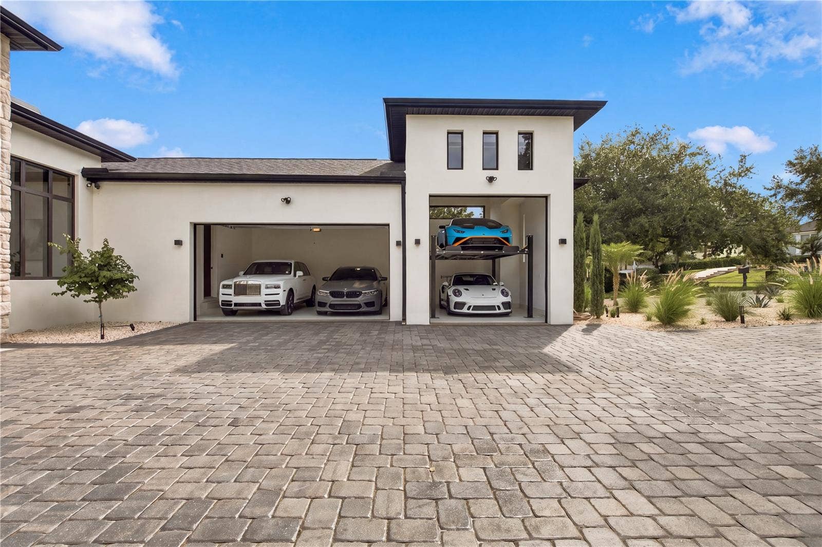 cars and lift are virtually staged to show size of garage.