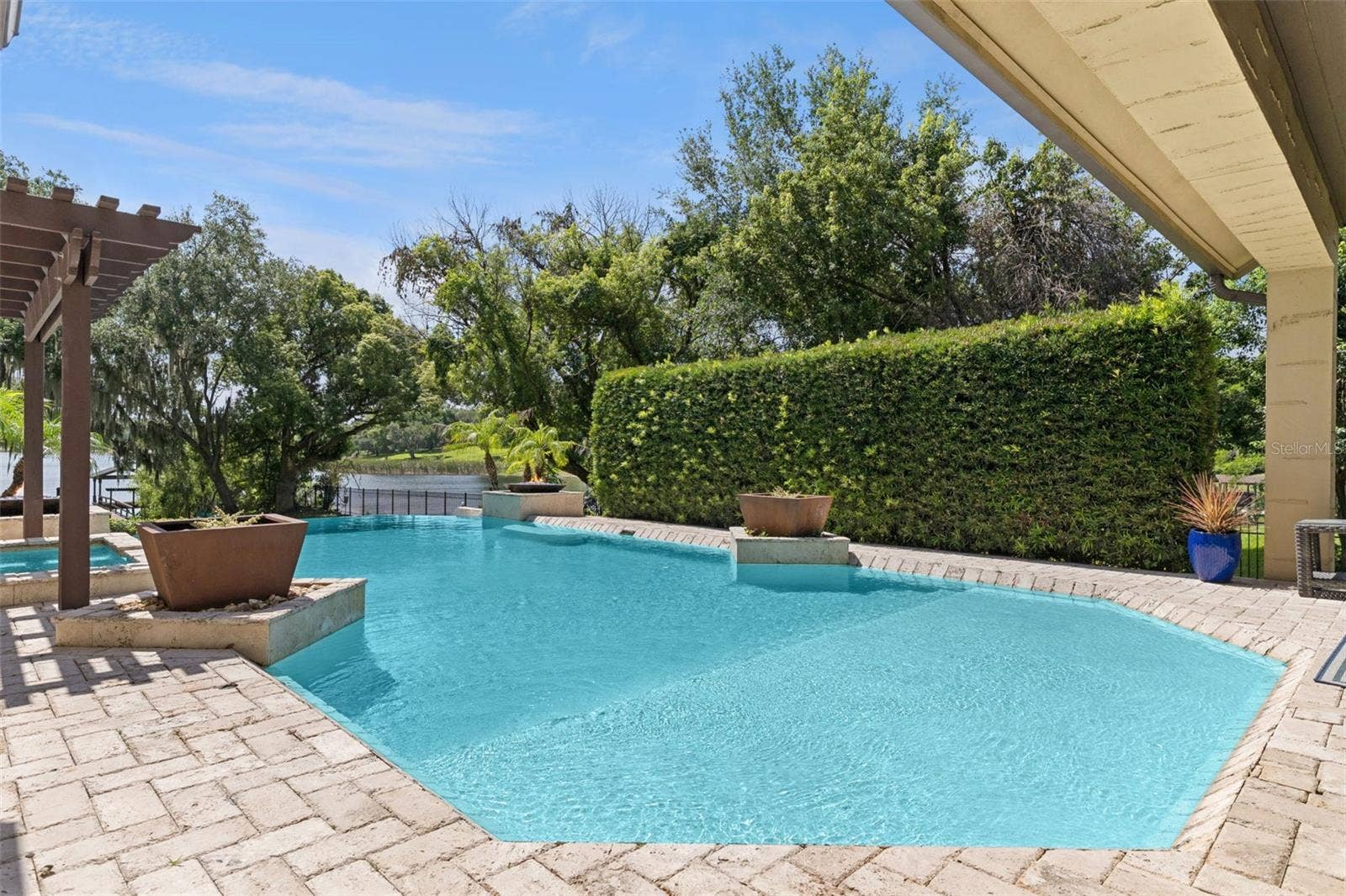 1629 HEMPEL AVENUE, Windermere, FL 34786 Large hedge provides privacy. Pool has baja shelf for that tanning in the water