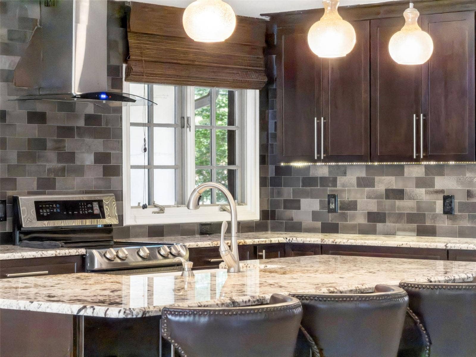 1629 HEMPEL AVENUE, Windermere, FL 34786 Under cabinet lighting, Stainless exhaust and Natural light enhance the kitchen.
