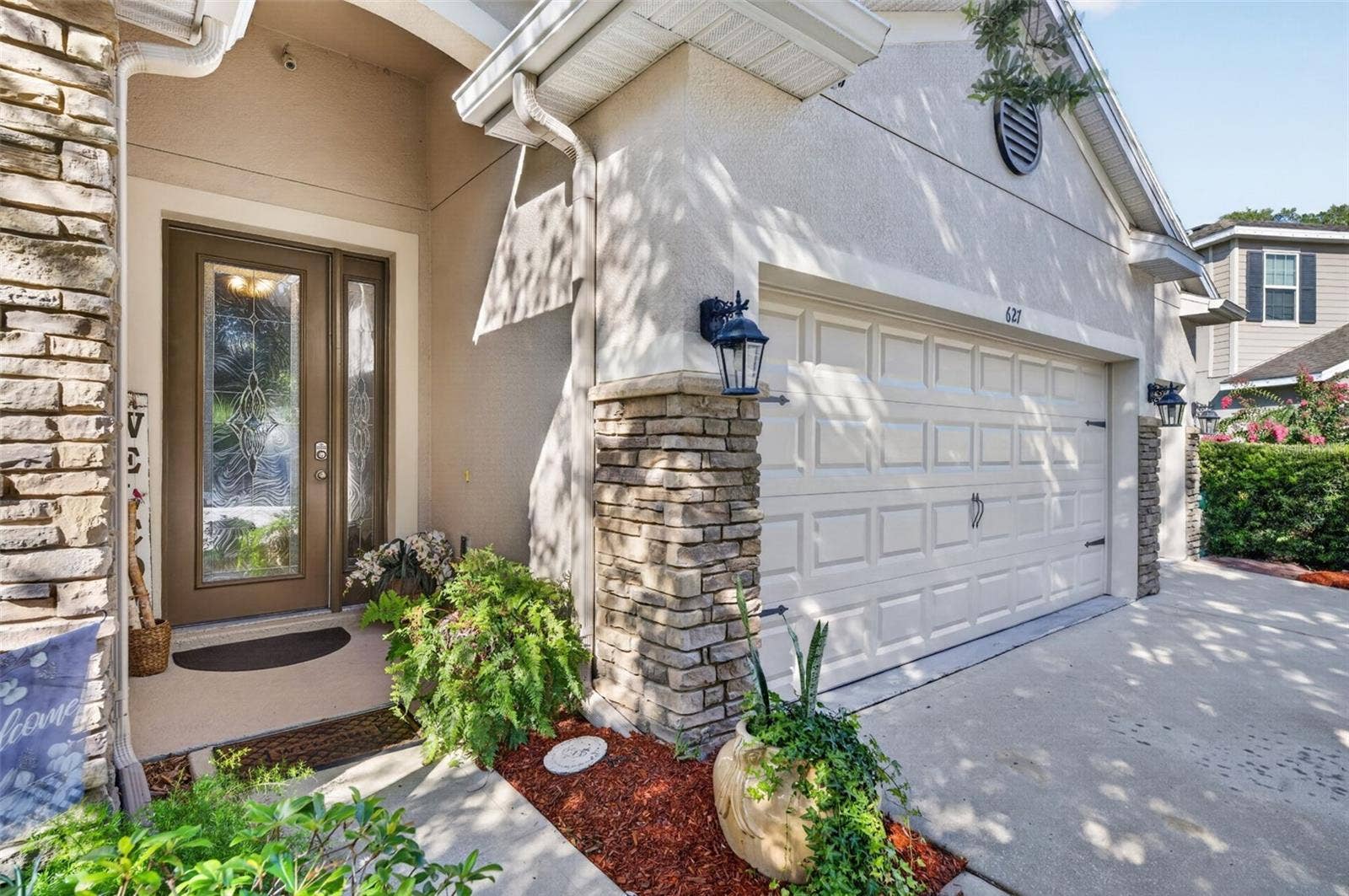 627 MEADOW SAGE DRIVE, DeLand, FL 32724 Front Entrance showcasing the brick and lovely garden alcove