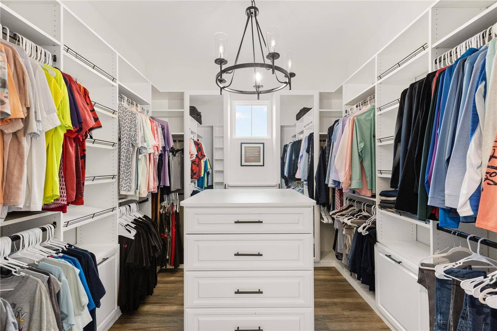 907 CELADON STREET, Winter Garden, FL 34787 Primary closet, hallway between bedroom suite and full bath.
