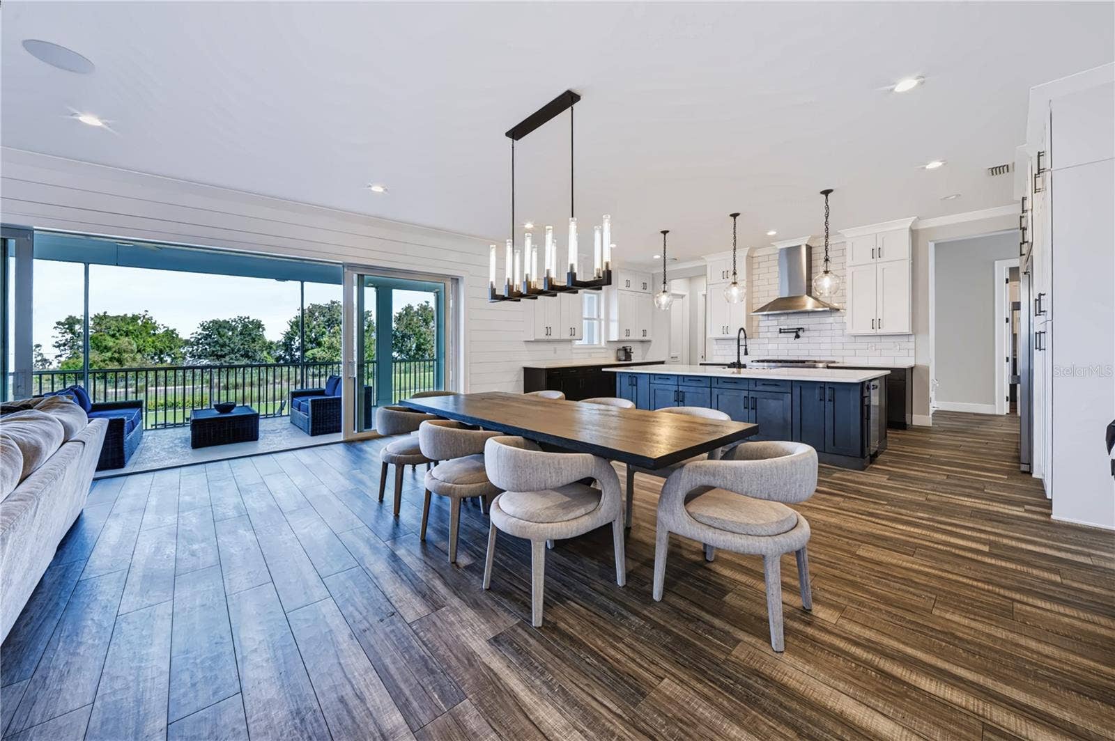 907 CELADON STREET, Winter Garden, FL 34787 the heart of this home is connected by grand sliding doors opening to an expansive porch over conservation and Lake Apopka.