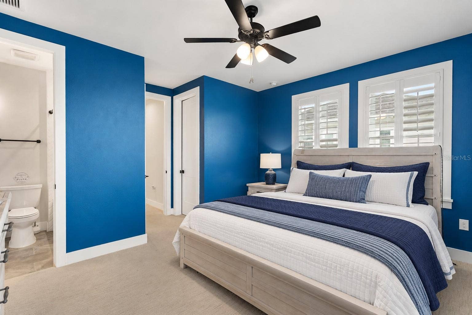 907 CELADON STREET, Winter Garden, FL 34787 SECOND STORY | 4TH BEDROOM/JACK & JILL. On back side of property facing conservation. Virtual Staged: removed - leaning mirror, wall pictures, items side table. Added: Bedding, lamp.
