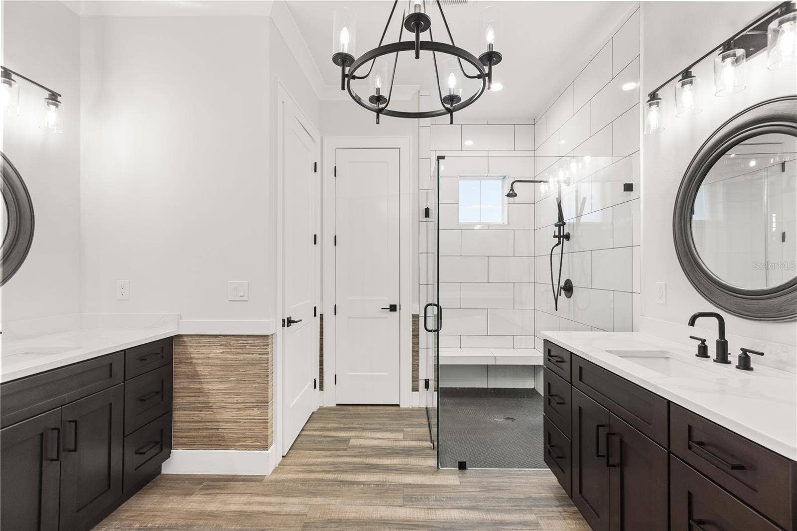 907 CELADON STREET, Winter Garden, FL 34787 Primary bathroom, dual sinks across. Linen closet (direct facing), and toilet room (left)