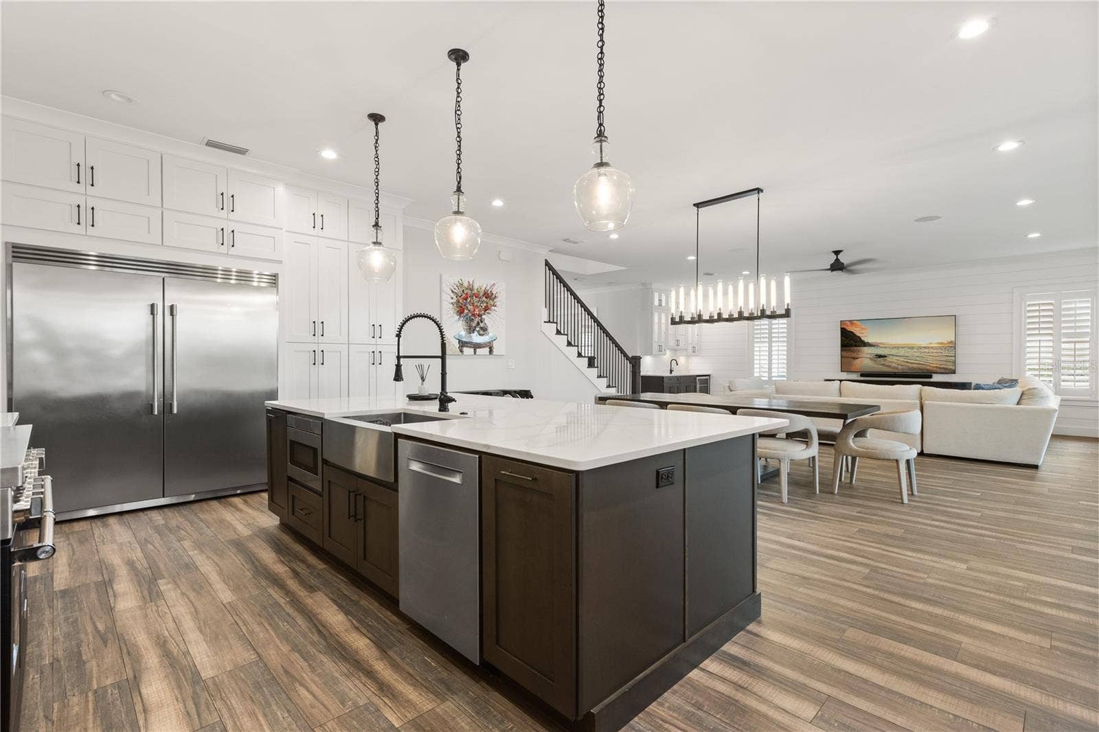 907 CELADON STREET, Winter Garden, FL 34787 OVERSIZED CENTER ISLANDAn oversized center island with apron-front sink and integrated appliances anchors the kitchen while remaining completely open to the dining and living areas.