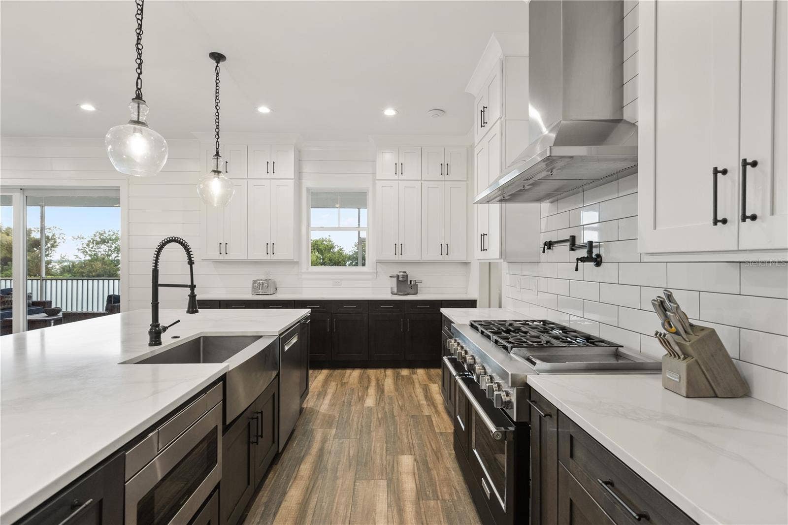 907 CELADON STREET, Winter Garden, FL 34787 DESIGNED FOR COOKING + ENTERTAININGThe gourmet kitchen pairs an oversized center island with an apron-front sink, professional-style range, pot filler, vent hood and extensive cabinetry.