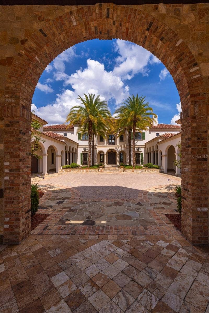 6119 GROSVENOR SHORE DRIVE, Windermere, FL 34786 porte cache entrance with brick detail s