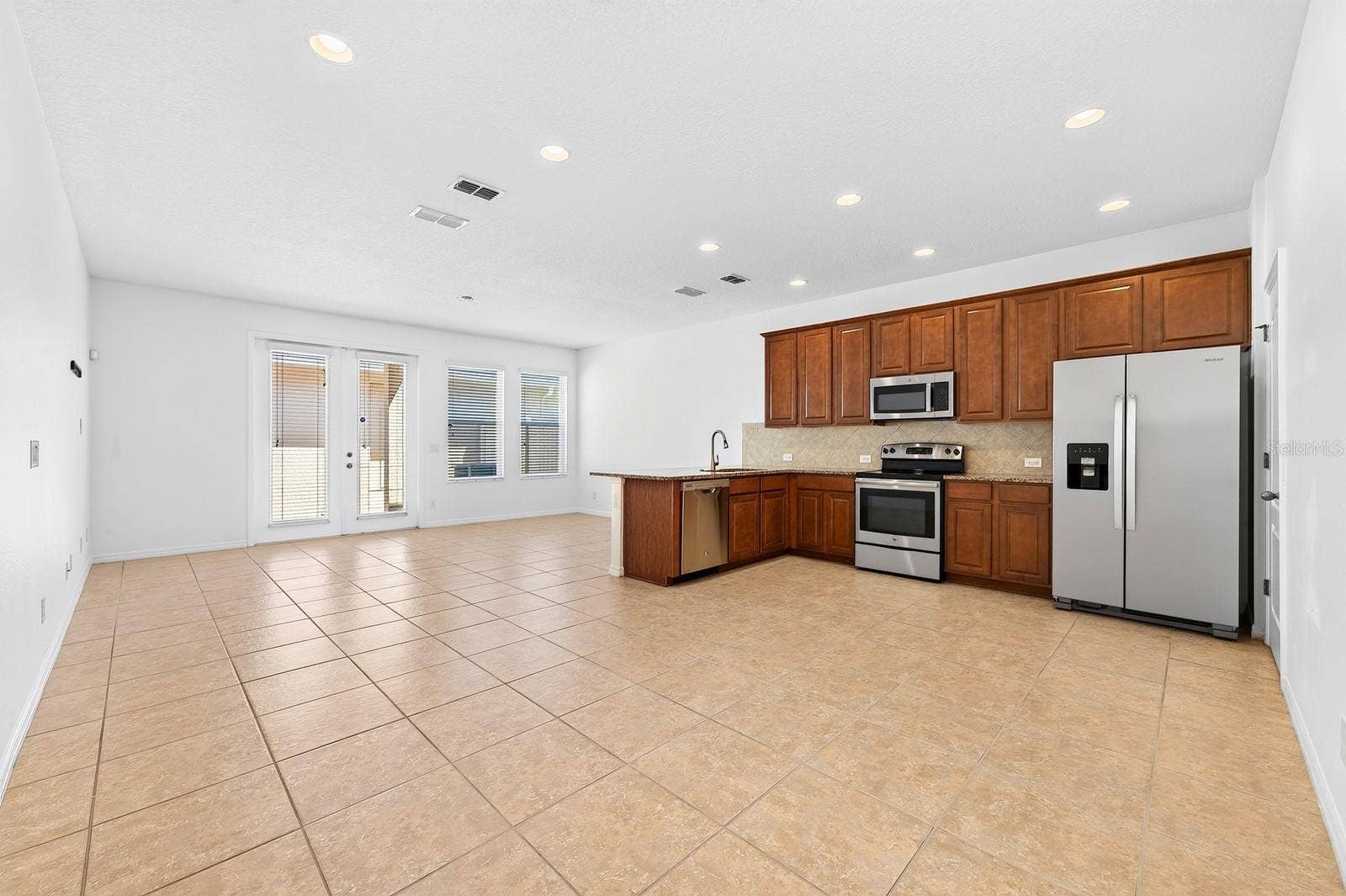 11429 BROWNSTONE STREET, Windermere, FL 34786 Inside, TILE & WOOD LAMINATE FLOORING flow throughout the home, while the light-filled OPEN CONCEPT design makes everyday living and entertaining effortless.