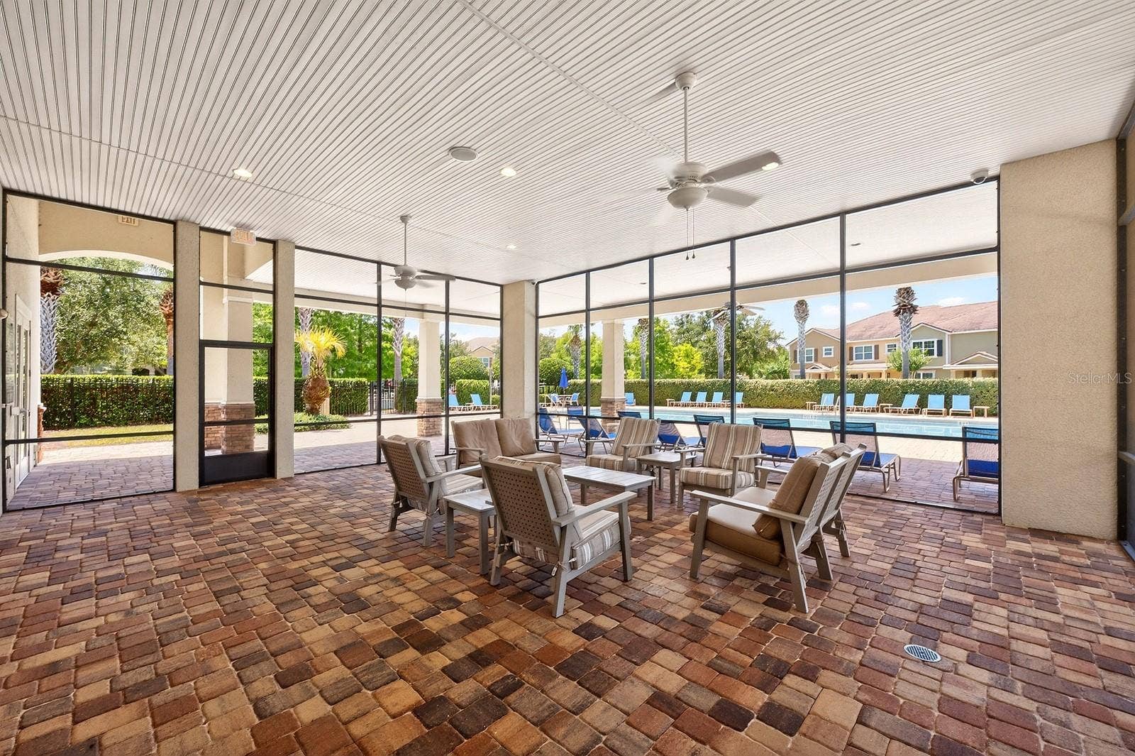 11429 BROWNSTONE STREET, Windermere, FL 34786 Relax comfortably in the poolside lanai.