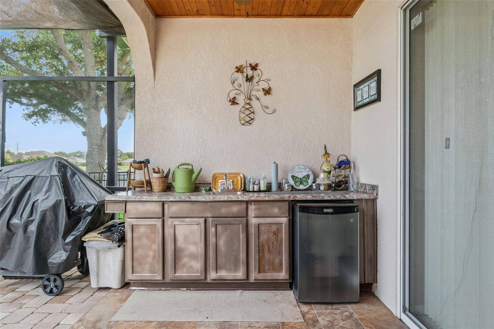 9955 MEDALLION BLUFF LANE, Orlando, FL 32829 Patio equipped with an outdoor sink, built in countertop and mini refrigerator