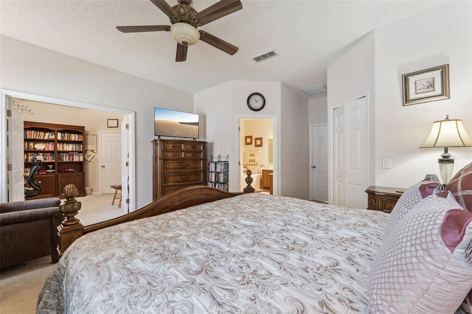 9955 MEDALLION BLUFF LANE, Orlando, FL 32829 Primary Bedroom features double doors that open to the fourth bedroom which is currently used as a home oiffice