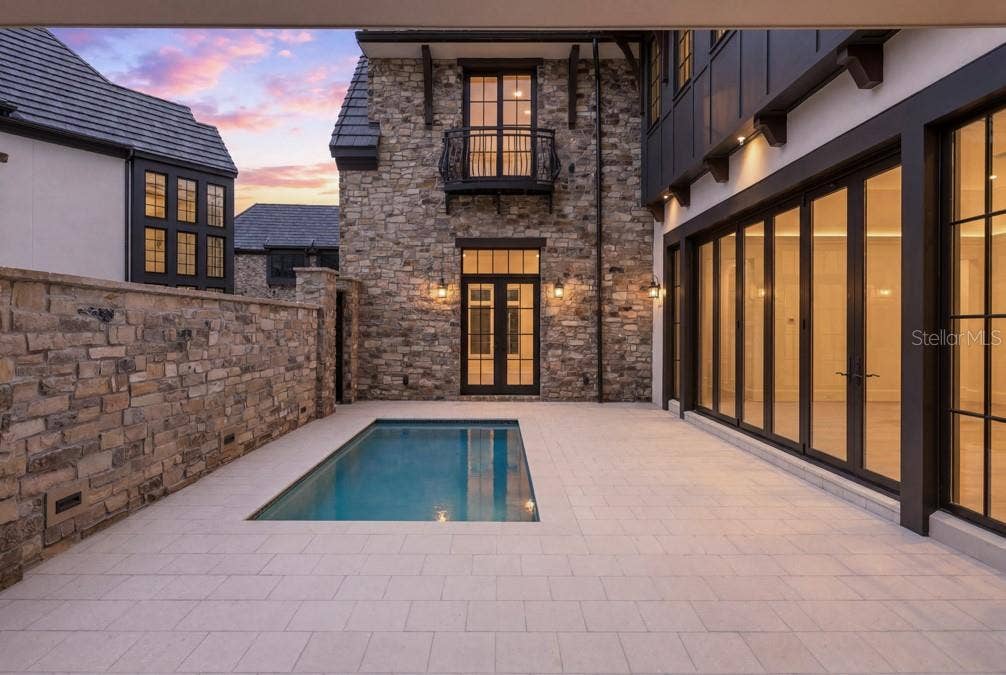 10335 WINTER SPARKLE CIRCLE, Golden Oak, FL 32836 Outdoor living area with summer kitchen and heated lounging pool