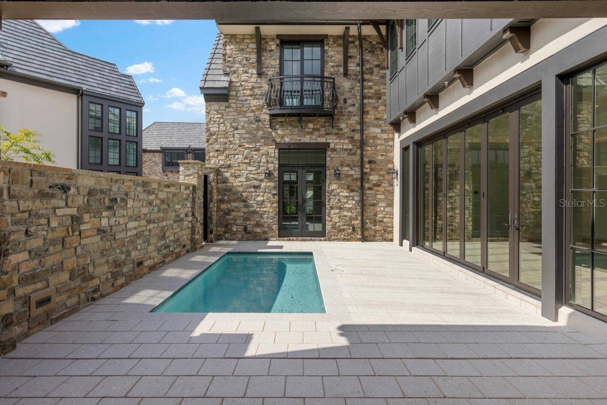 10335 WINTER SPARKLE CIRCLE, Golden Oak, FL 32836 Outdoor living area with summer kitchen and heated lounging pool