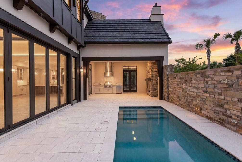 10335 WINTER SPARKLE CIRCLE, Golden Oak, FL 32836 Outdoor living area with summer kitchen and heated lounging pool
