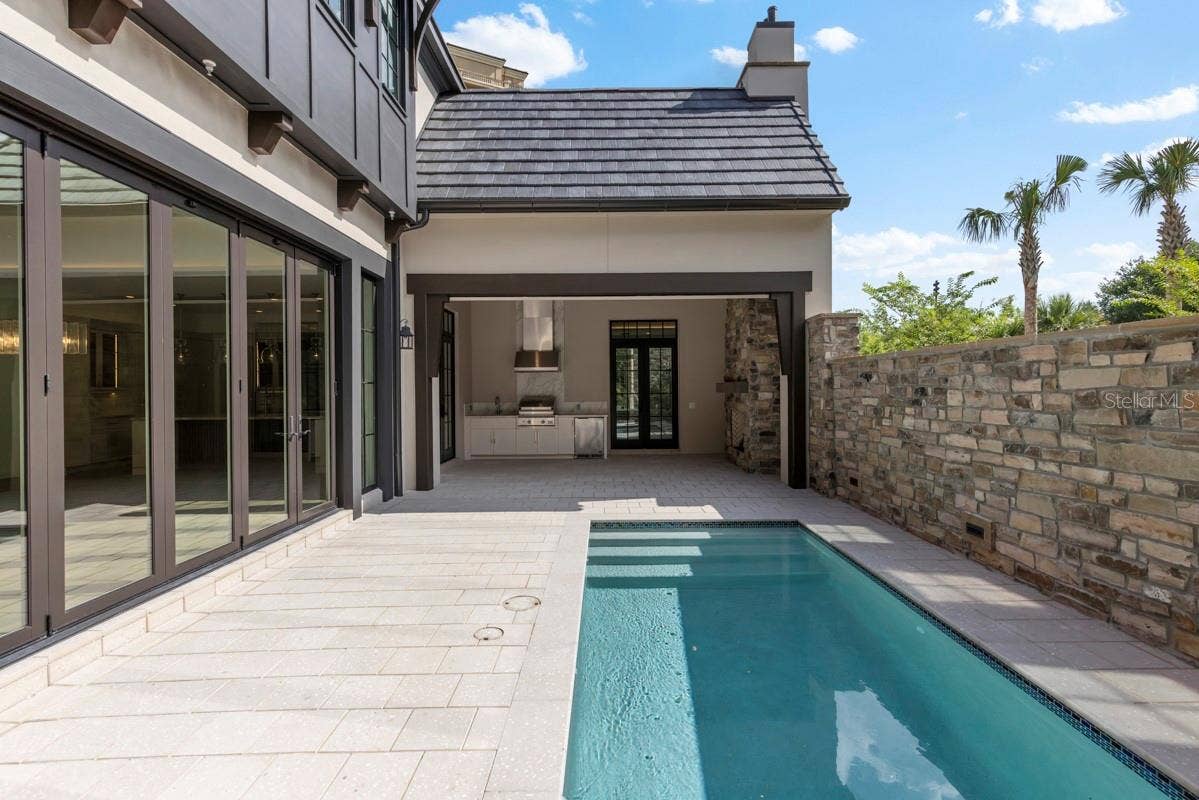 10335 WINTER SPARKLE CIRCLE, Golden Oak, FL 32836 Outdoor living area with summer kitchen and heated lounging pool