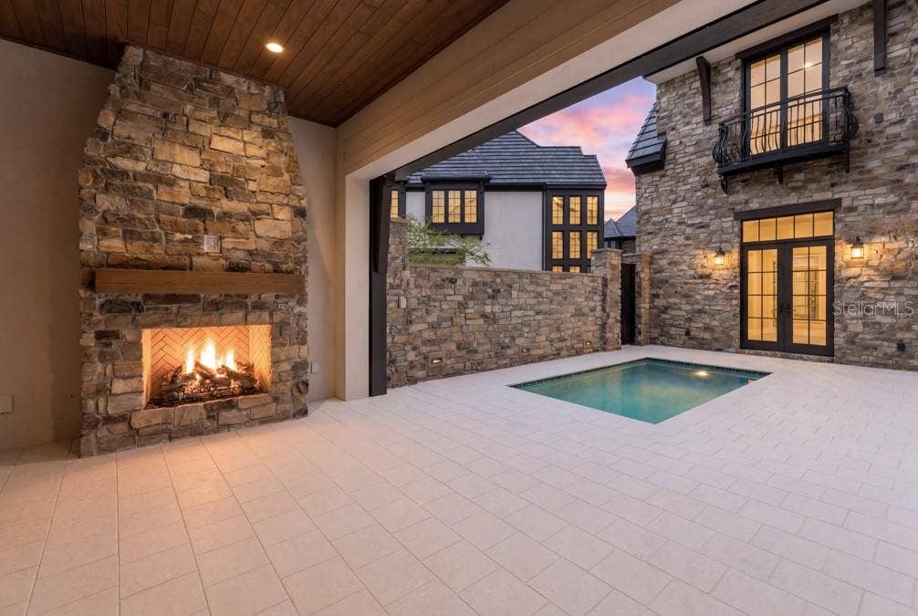 10335 WINTER SPARKLE CIRCLE, Golden Oak, FL 32836 Outdoor living area with summer kitchen and heated lounging pool